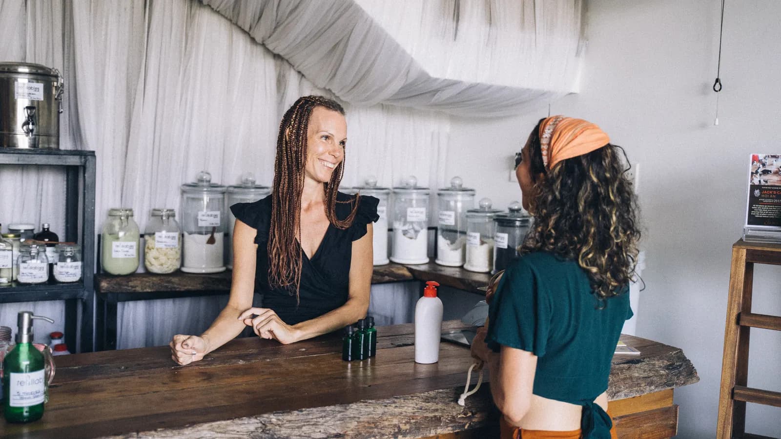 Shop owner talking with a customer at the store counter